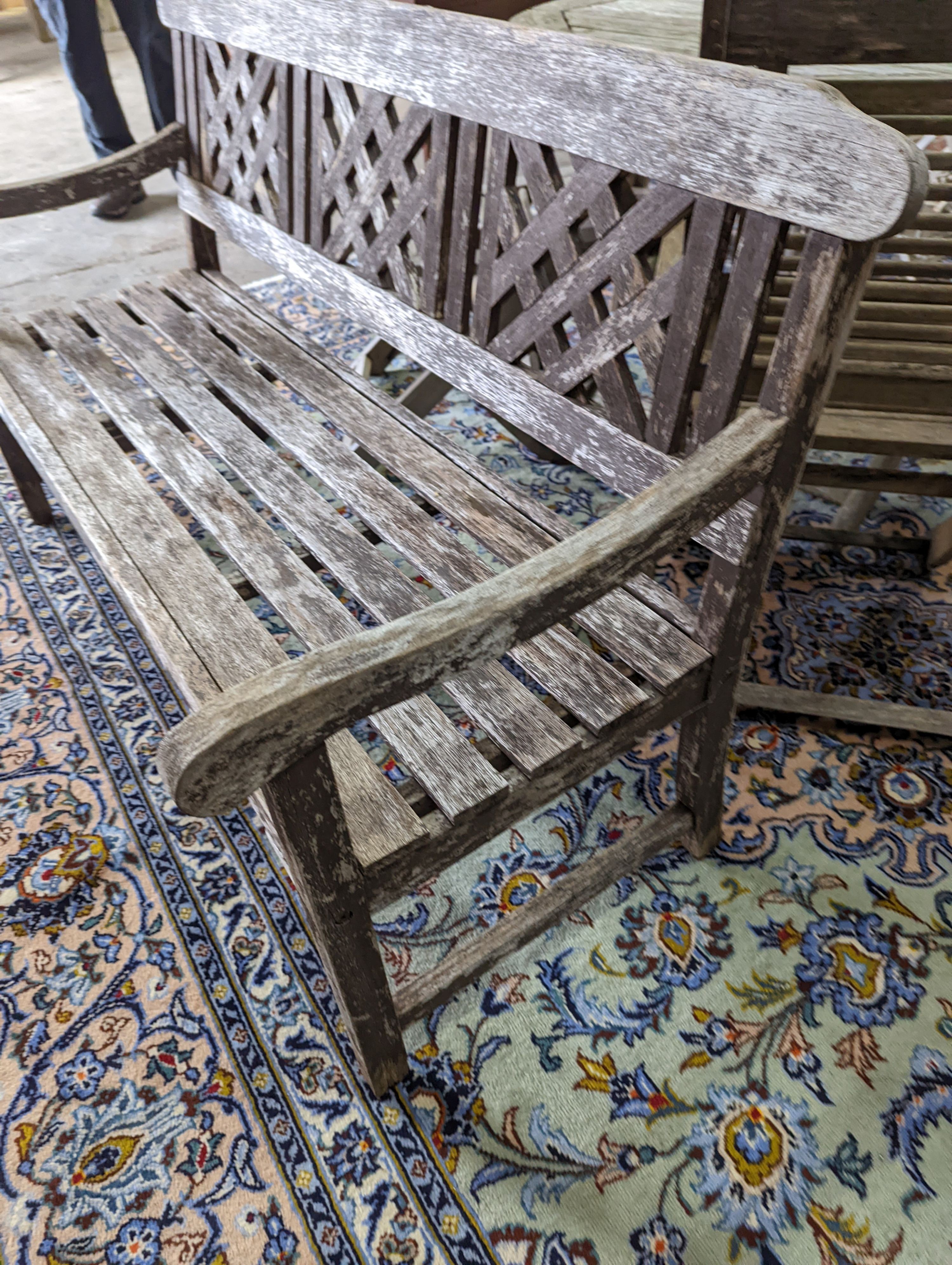 A weathered teak garden bench, length 146cm, depth 50cm, height 86cm